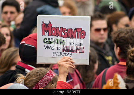 New York, NY, May 25, 2013.  A woman holds a sign denouncing Monsanto as people in New York's Union Square rally against the U.S.-based agriculture and biotechnology corporation.  The rally and subsequent march was one of many across the U.S. and in dozens of other countries.  Organizers hope to spread the word about what they say are the harmful effects of genetically modified foods. Stock Photo