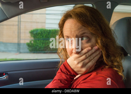 Embarrassed woman's expression after car incident Stock Photo