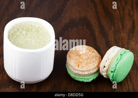 Matcha latte made with almond milk and apple cinnamon macarons Stock Photo