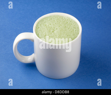 Matcha latte made with almond milk served in mug Stock Photo