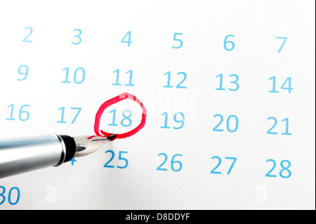 Red circle marked on a calendar with a pen Stock Photo