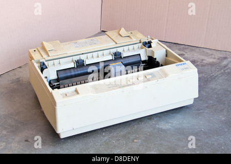 Dirty dot matrix printer. Concept of obsolete IT technology. Stock Photo