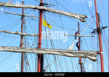 Ship Climbing Rigging Sailors climb the mast of a tall sailing ship to effect maintenance and ...