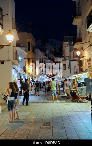 Shoppers take in the sights of Ibiza Town By Night Stock Photo
