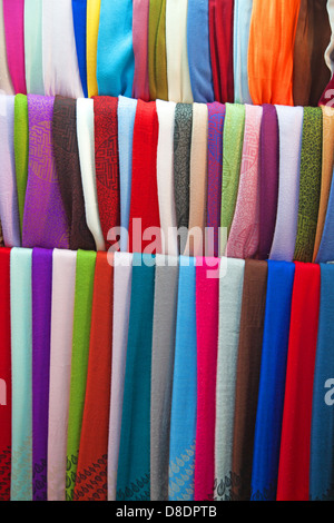 Colorful cashmere shawls hanging together background Stock Photo