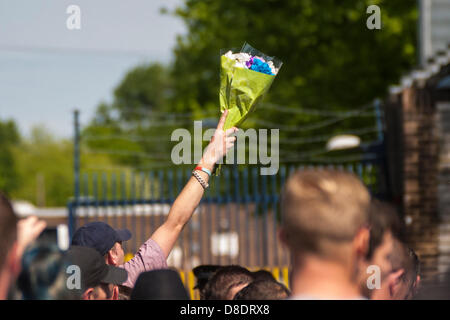 Woolwich, London, UK. 26th May, 2013. A bouquet is held aloft as hundreds of English Defence League activists and their supporters visit the entrance of the barracks in Woolwich to pay their respects to murdered soldier Drummer Lee Rigby. Credit: Paul Davey/Alamy Live News Stock Photo