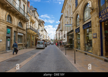 Rue de la Republique, the main street in Sarlat, lined with shops in medieval sandstone buildings, Dordogne region of France Stock Photo