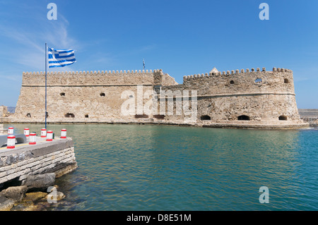 Greek flag before the the Venetian fortress of Rocca al Mare or Koules, Heraklion, Crete, Greece Stock Photo