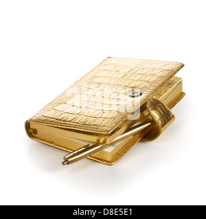 Luxury golden leather notebook with pen on white background Stock Photo