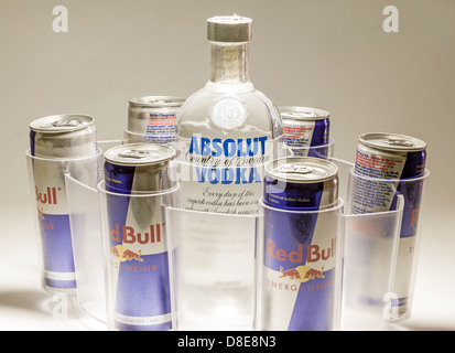 Cacak, Serbia - May 20, 2013: Six Red Bull Cans and Absolut Vodka, studio isolated. Stock Photo