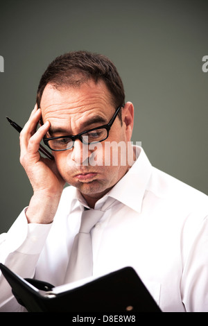 Businessman looking in diary Stock Photo