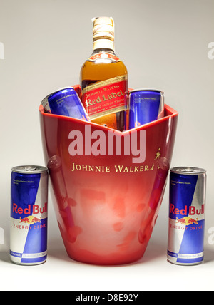 Cacak, Serbia - May 20, 2013: Four Red Bull Cans and Johnnie Walker Whiskey, studio isolated. Stock Photo