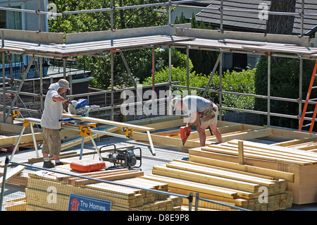 Two carpenters working on a new house Stock Photo