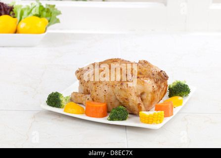 Eatable whole roasted chicken served with vegetable Stock Photo