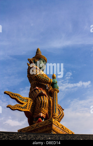 Giant guardian statue at the Temple of Wat Phasrisanpet, Ayuttaya, Thailand with blue sky Stock Photo