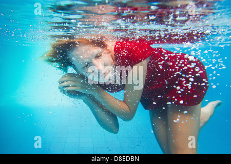 imagination, underwater portrait of woman in red dress Stock Photo