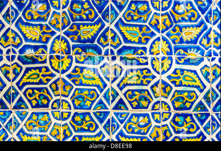 Tiled abstract background, beautiful blue and yellow decorated tile, vintage porcelain, ancient wall in the church Stock Photo