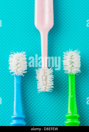 Closeup of three old and well used toothbrushes viewed from above Stock Photo