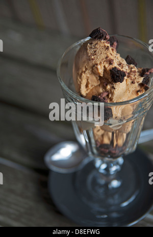 Caramel Icecream with broken Oreo cookies. Stock Photo