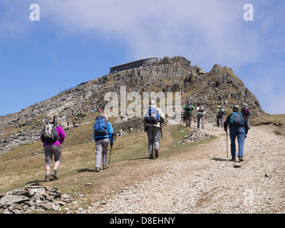 Hikers hiking on Rhyd Ddu path up to Mount Snowdon summit cafe (Hafod Eryri) in Snowdonia National Park North Wales UK Britain Stock Photo