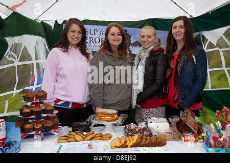 Turton, Lancashire, UK 27th May 2013. Help the Hero's Stall with Laura Carruthers 20, Liz Turner 20, Vicky Stewart 20, and Katie Pamphilan 21 from London at the annual traditional spring fair held in the grounds of the 600-year-old Turton Tower.  The event dates back more than 200 years, but went into decline in the early 20th century. It was revived in 2008 by the Friends of Turton Tower. Stock Photo