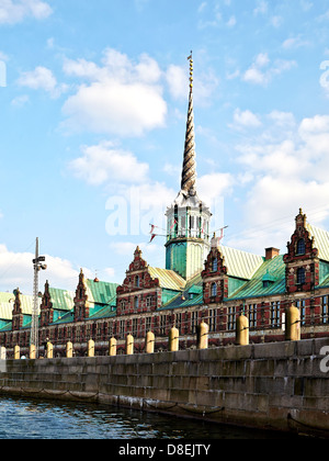 Børsen, the farmer Stock Exchange, in central Copenhagen was built by Christian IV in 1619–1640 and is the oldest stock exchange in Denmark. The building is 127 metres long and the Dragon Spire shaped as the tails of four dragons twined together, has a height of 56 metres. Stock Photo