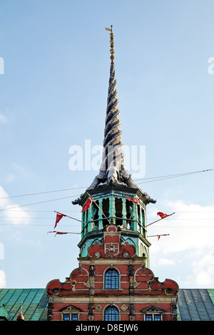 Børsen, the farmer Stock Exchange, in central Copenhagen was built by Christian IV in 1619–1640 and is the oldest stock exchange in Denmark. The building is 127 metres long and the Dragon Spire shaped as the tails of four dragons twined together, has a height of 56 metres. Stock Photo