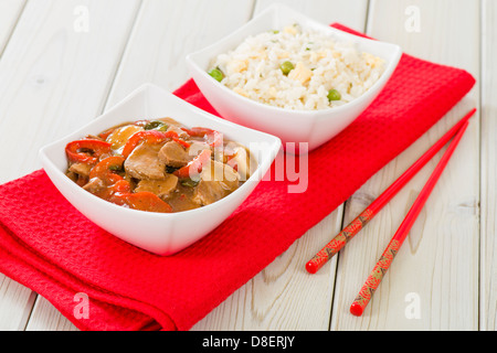 Chinese style pork with red peppers served with egg fried rice. Stock Photo