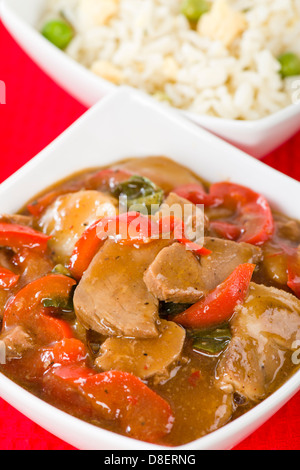 Chinese style pork with red peppers served with egg fried rice. Stock Photo