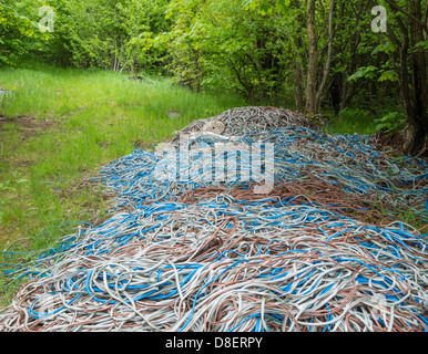 Pile of outer cables stripped of copper metals dumped in countryside      Quick Pricing     Custom Pricing Stock Photo