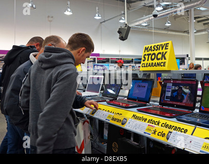 Customers looking at laptops in PC World computer store, UK Stock Photo