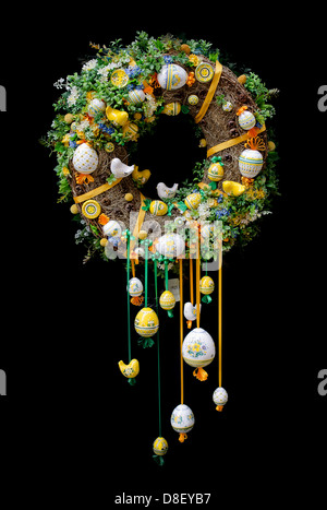 Colorful and festive Easter wreath with decorated eggs isolated on black Stock Photo
