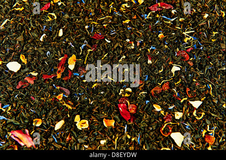 Dried tea leaves mixed with dried fruit as background Stock Photo
