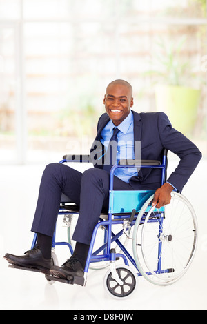 optimistic disabled african american businessman sitting on wheelchair Stock Photo