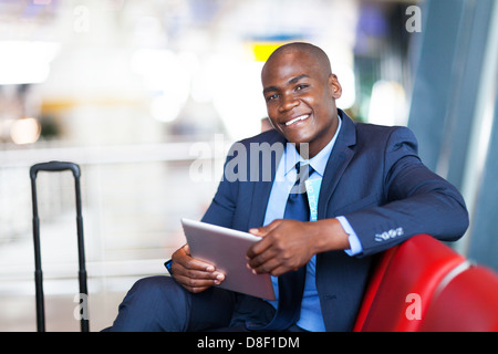 african business traveller using tablet computer at airport Stock Photo