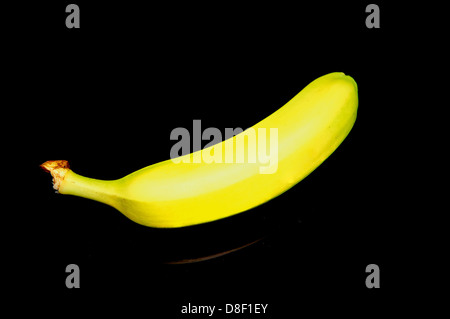 Banana on reflecting black table Stock Photo