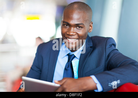 handsome african businessman using tablet computer at airport Stock Photo