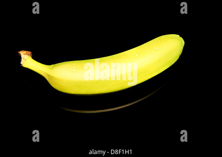 Banana on reflecting black table Stock Photo