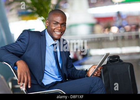 handsome african businessman using tablet computer in airport Stock Photo