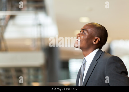 optimistic african american businessman looking up Stock Photo