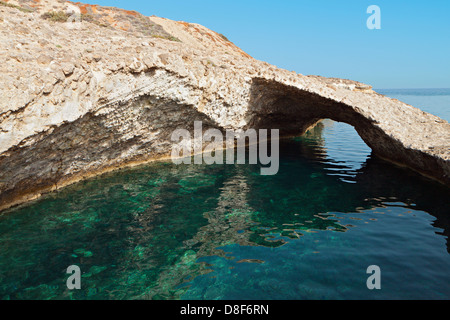 Caves and rock formations by the sea at Milos island in Greece Stock Photo