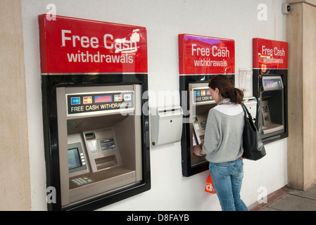 woman at ATM, free cash withdrawals Stock Photo
