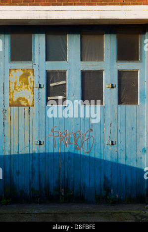 Graffiti on old garage doors, Brighton, UK Stock Photo
