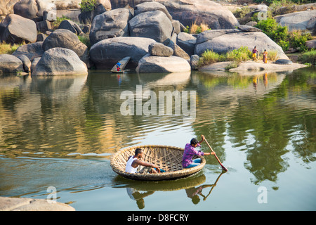 Traditional coracle boat on the Tungabhadra river in Hampi, India Stock Photo