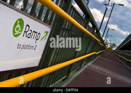 Sign showing ramp access to bridge for disabled users at a Stratford-upon-Avon Parkway station. Stock Photo