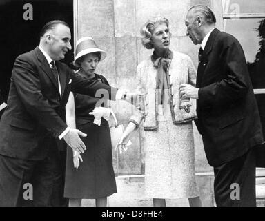 German chancellor Konrad Adenauer (r) meets French prime minister Georges Pompidou (l) during his official visit to France on the 3rd of July in 1962 in paris. Mrs Reiners (2nd of left), Adenauer's daughter, stands next to Madame Pompidou. Stock Photo