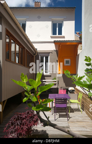 A small holiday house with its wooden extension (France). Petite maison de vacances avec une extension en bois (France). Stock Photo