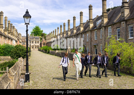 Boys from the Cathedral School in Wells, Somerset UK - people walking down Vicars Close Stock Photo