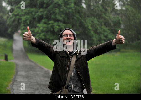 LONDON, UK. 28th May 2013. Heavy rain falls in London. Alex Mullane, 26, from Northolt, enjoys the rain in a deserted Hyde Park. Credit: Polly Thomas / Alamy Live News Stock Photo