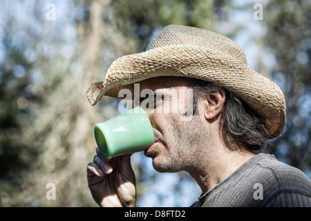 Man drinking coffee, outdoors Stock Photo